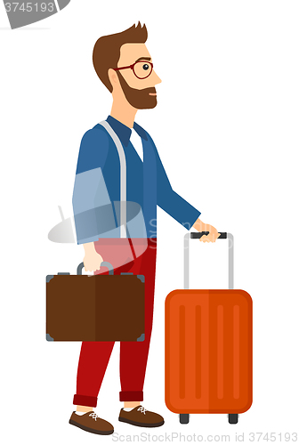 Image of Man with suitcase on wheels and briefcase.