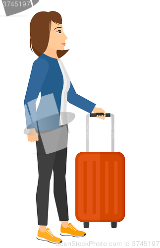 Image of Woman standing with suitcase.