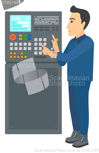 Image of Engineer standing near control panel.