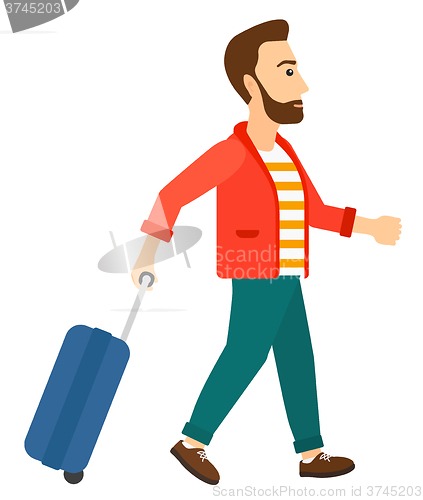 Image of Man walking with suitcase.