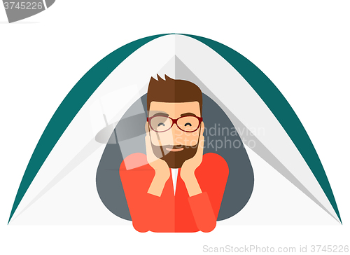 Image of Man lying in tent.