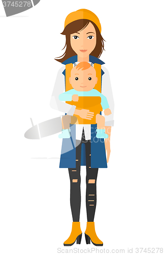 Image of Woman holding baby in sling.