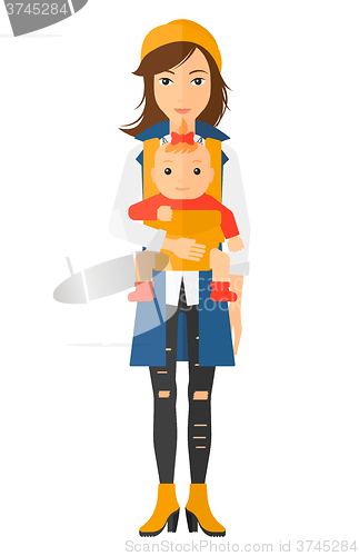 Image of Woman holding baby in sling.