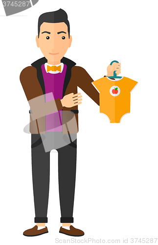 Image of Man holding clothes for baby.