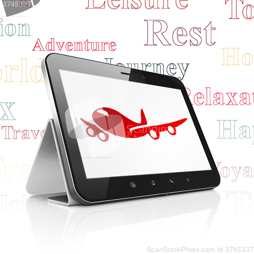 Image of Vacation concept: Tablet Computer with Airplane on display
