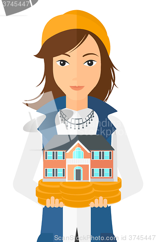 Image of Woman holding house model.