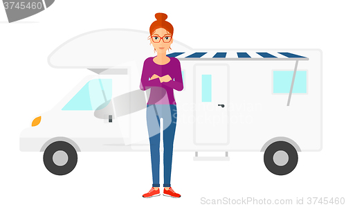 Image of Woman standing in front of motor home.