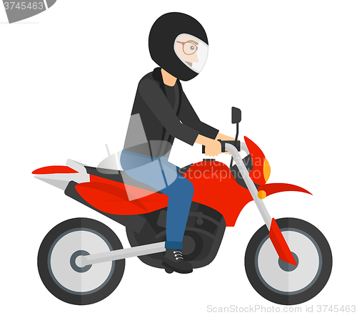 Image of Man riding motorcycle.