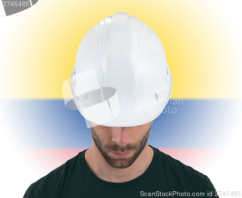 Image of Engineer with flag on background - Colombia