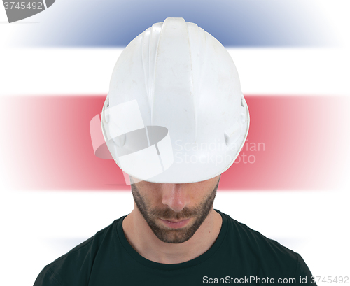 Image of Engineer with flag on background - Costa Rica