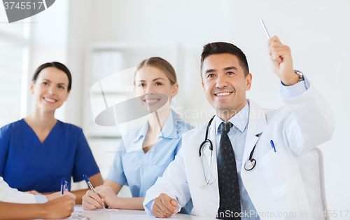 Image of group of happy doctors on conference at hospital