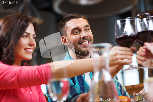 Image of friends clinking glasses of wine at restaurant