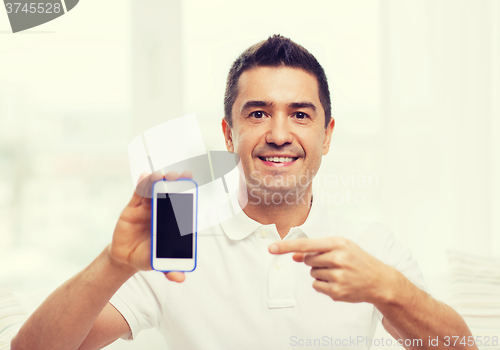 Image of happy man with smartphone at home