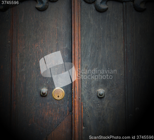 Image of handle in london antique brown door  rusty  brass nail and light