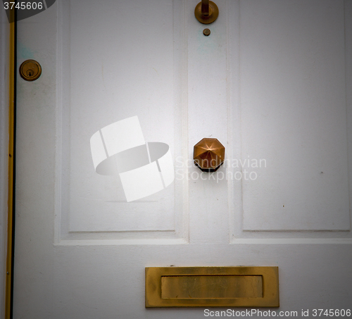 Image of handle in london antique brown door  rusty  brass nail and light