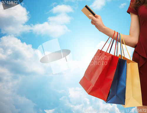 Image of close up of woman with shopping bags and bank card