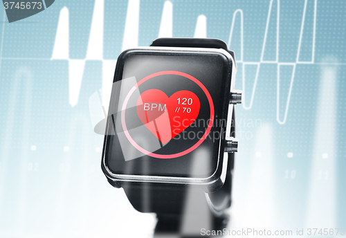 Image of close up of black smart watch with heart beat icon