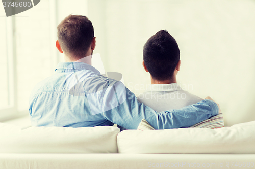 Image of close up of happy male gay couple hugging