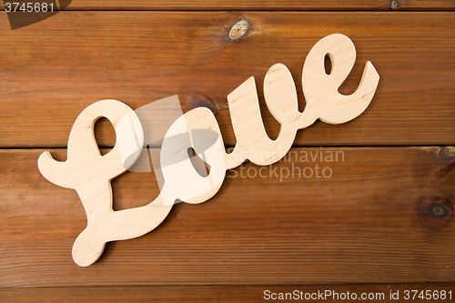 Image of close up of word love cutout on wood