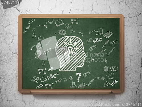 Image of Learning concept: Head With Light Bulb on School Board background