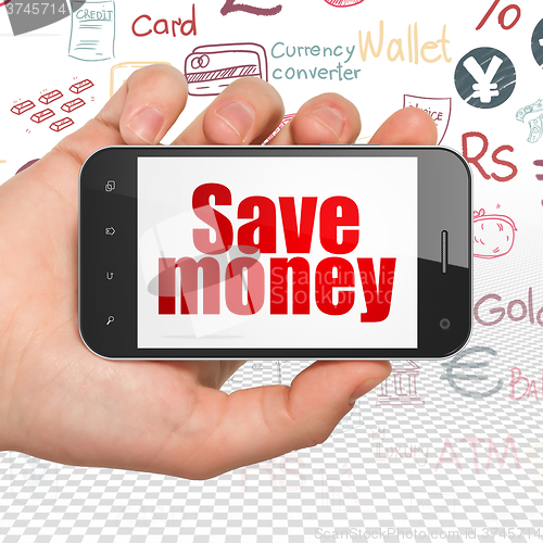 Image of Money concept: Hand Holding Smartphone with Save Money on display