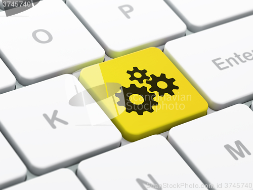 Image of Information concept: Gears on computer keyboard background