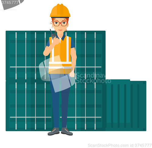 Image of Stevedore standing on cargo containers background.