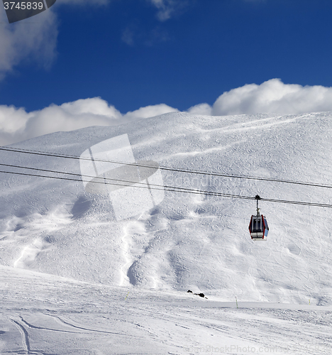 Image of Gondola lift and ski slope at sun day