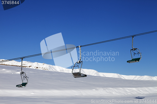 Image of Chair-lift and blue sky at sun day