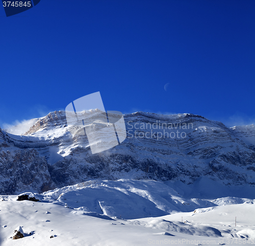 Image of Snowy rocks at sun windy day