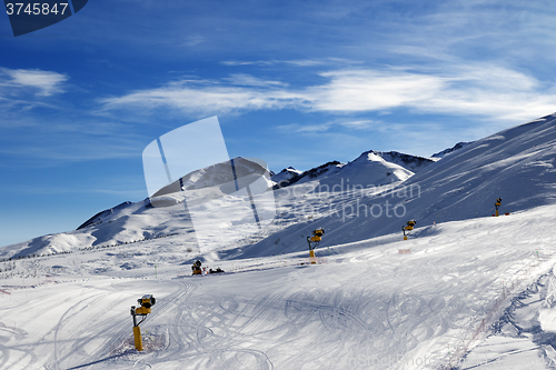 Image of Ski slope with snowmaking at sun morning