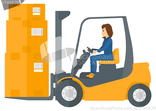 Image of Worker moving load by forklift truck.