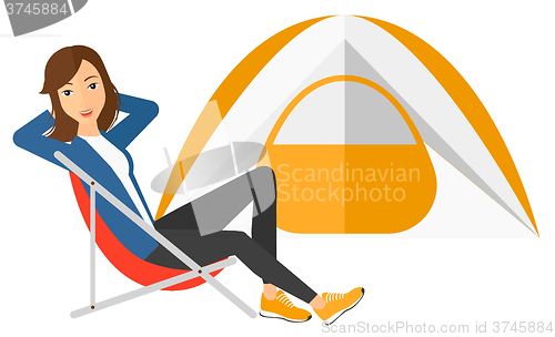 Image of Woman sitting in folding chair.