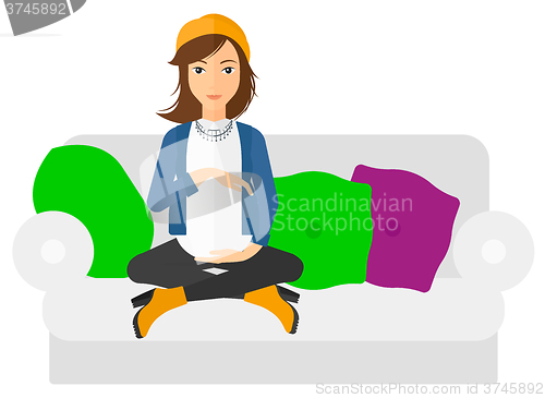 Image of Pregnant woman sitting on sofa.