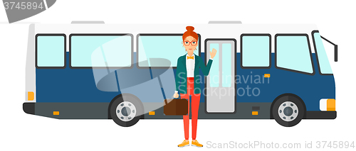 Image of Woman standing near bus.