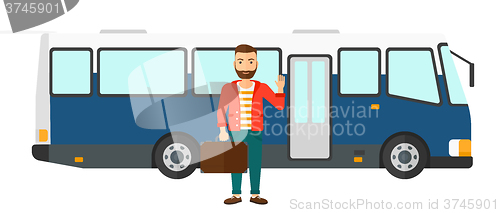 Image of Man standing near bus.