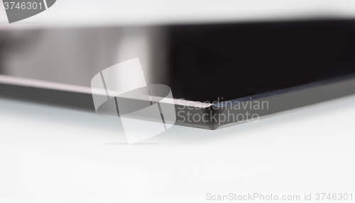Image of black sheet glass on a white. closeup