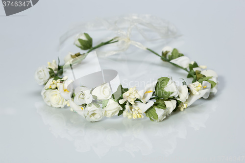 Image of tiara of artificial  roses on a light background