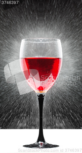 Image of glass with red wine. splashing water