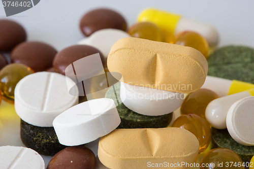 Image of Pile of various colorful pills isolated on white