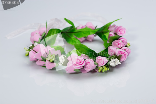 Image of tiara of artificial  roses on a light background