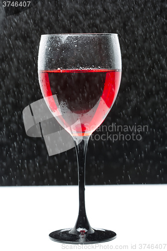 Image of glass with red wine. splashing water