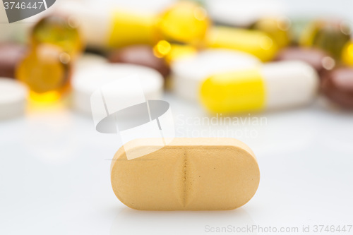 Image of Pile of various colorful pills isolated on white