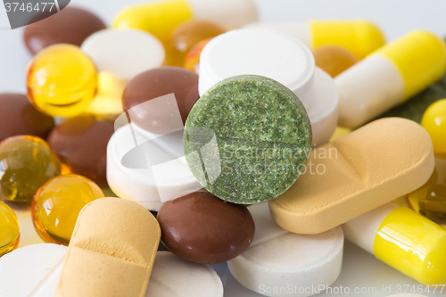 Image of Pile of various colorful pills isolated on white