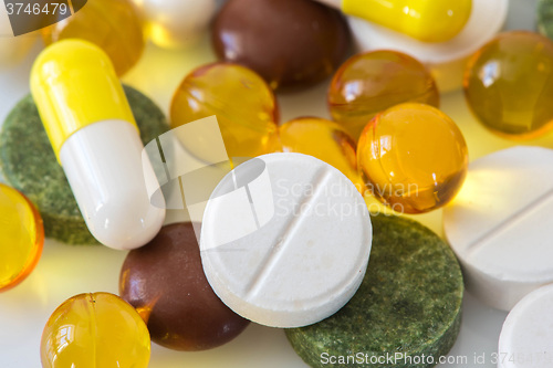 Image of Pile of various colorful pills isolated on white