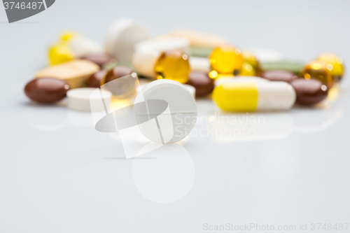 Image of Pile of various colorful pills isolated on white