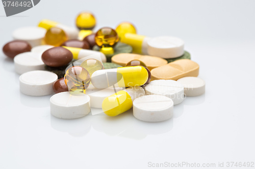 Image of Pile of various colorful pills isolated on white