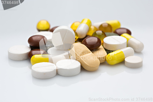 Image of Pile of various colorful pills isolated on white