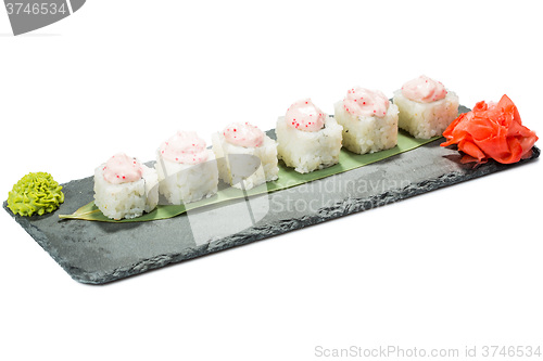 Image of set of sushi on black slate substrate, isolated white background