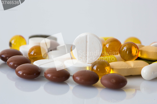 Image of Pile of various colorful pills isolated on white